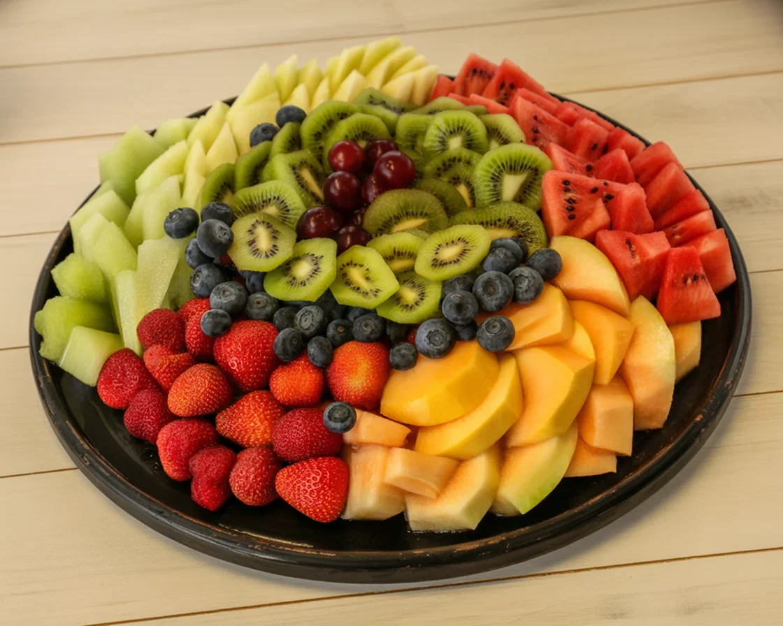 A colorful and fresh fruit platter featuring strawberries, watermelon, and grapes.