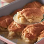 Delicious homemade apple dumplings topped with syrup and served warm.