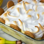 Delicious homemade banana pudding layered with vanilla wafers and topped with fluffy meringue.